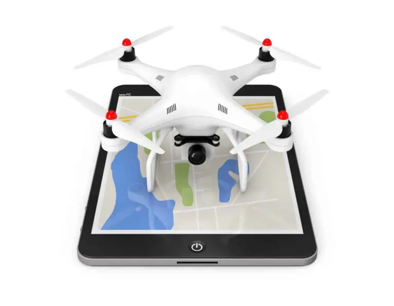 White quadcopter drone placed on an ipad